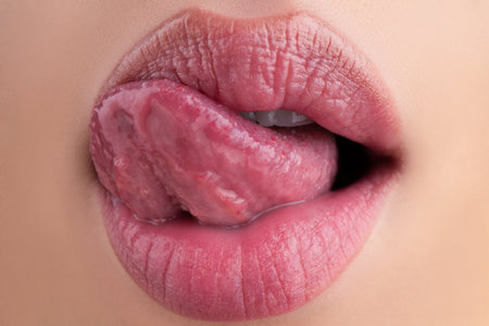 Sensual lick. Macro tongue lick lips. Close up of woman mouth.