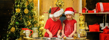 Kids making christmas cookies. Merry Christmas. Christmas food and drink. Little friends boy and...