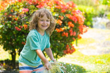 Child is watering the plant outside the house, concept of plant growing learning activity for kids and children education for the nature.の写真素材