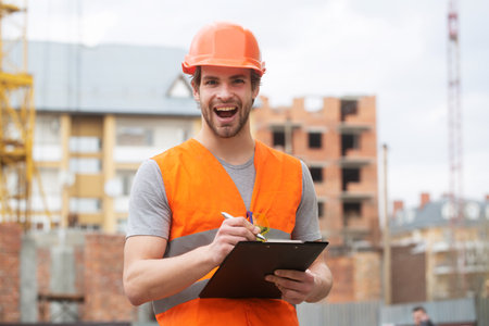 Portrait of construction builder. Construction worker man in work clothes and a construction helmet.