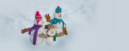 Snowman couple and snowman in winter. Holiday poster design.の写真素材