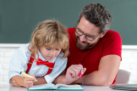 School kid and teacher learning study in class. Nerd elementary school boy.