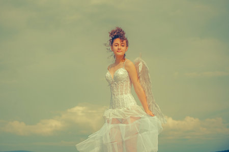 Teen cupid, valentine day. Teenager angel with angels wings.の写真素材