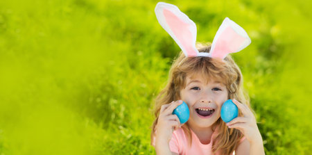 Happy easter holiday. Child in bunny ears hold Easter egg. Boy hunting easter egg. Panoramic web...