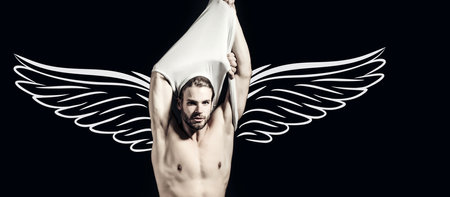 Naked muscular angel. Photo banner of sexy man with wings for valentines day. Sexy male model with bare nude torso. Sexy young handsome naked man on dark background. Seductive gay.の写真素材