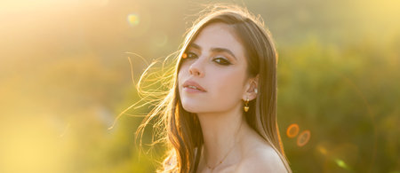 Spring woman on sunlight romantic portrait, sensual sunny face. Banner for website header. Natural...