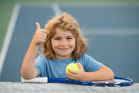 Tennis. Child playing tennis on indoor court. Little child with tennis racket and ball in sport club. Active exercise for kids. Summer activities for children. Training for young kid.の写真素材