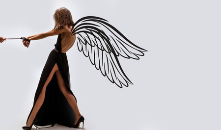 Sensual woman angel with wings. Valentines day panoramic photo banner. Bdsm, erotic games. Man dominating woman, temptation. Love, relations, dominating. Sexshop, foreplay.の写真素材