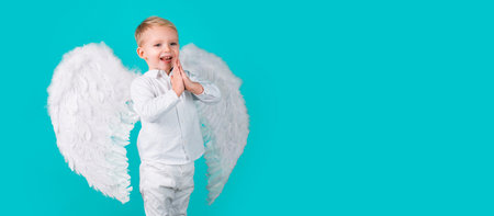 Angel kid banner, isolated studio background. Studio shot of little boy child as angel. Horizontal photo banner for website header design.の写真素材