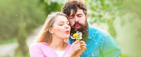 Couple in love, spring banner. Passion and sensual touch. Young lovely couple walking in spring park. Beautiful couple in love outside in spring nature.の写真素材