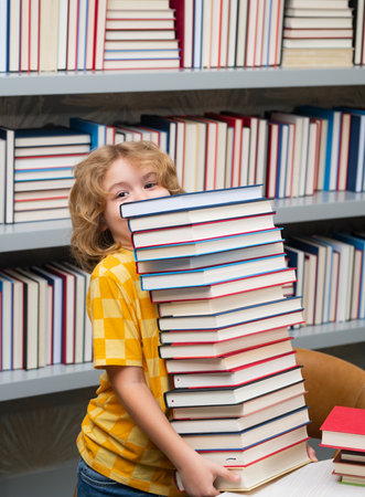 School bullying. School child studying in school library. Kid reading book in library on bookshelf...