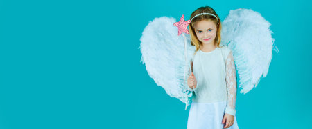 Valentines day banner with angel child. Pretty little angel girl. Valentines day. Christmas Cute little Angel. Cute toddler girl in white wings as Cupid.の写真素材