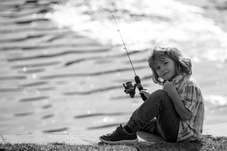 Young child fisher at river. Kid fishing, summer outdoor leisure activity. Little boy angling at...