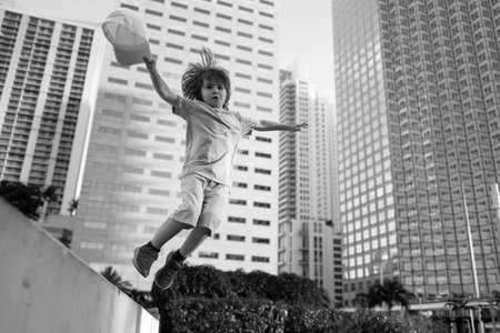 Child fun outdoor. Little boy jump on city street.の写真素材