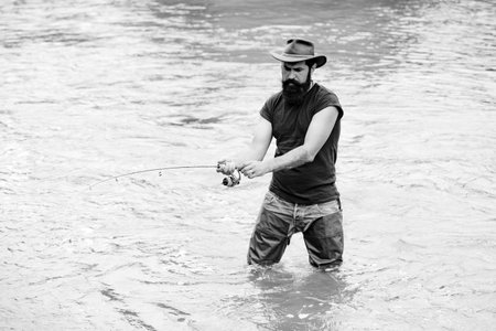 Man bearded fisher. Weekend time. Carry on fishing. Portrait cheerful man. Weekends made for fishing. Activity and hobby. Fly fishing adventures. Home of hobbies. Fisherman with fishing rod.の写真素材