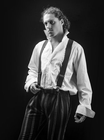 Man in a suit on a black background. In casual light shirt. Serious stylish man. Portrait of sporty...