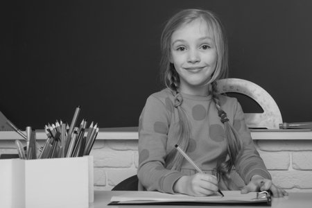 Schoolgirl doing homework. Education and study. Distance learning for kids. Homeschooling during...