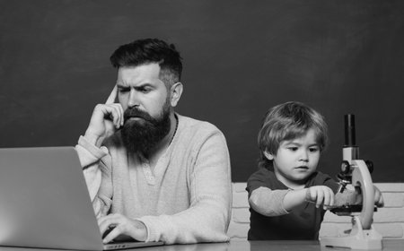 Man teacher play with preschooler child. Child learning. Daddy Teacher. Father and son. Daddy and son together. Tutoring. Elementary school teacher and student in classroom.の写真素材