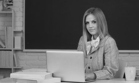 Young teacher. Female student on lesson lecture in classroom at high school or college.の写真素材