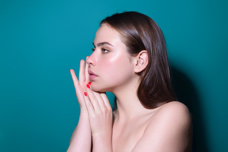 Close-up portrait of lovely pretty girl isolated over studio background. Beauty woman with perfect skin. Makeup and cosmetics. Natural makeup for beauty salon. Care cosmetics, face and body skin care.の写真素材