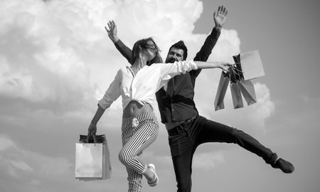 Always have a shopping bag with you. Happy shoppers carrying their purchases in shopping bags....