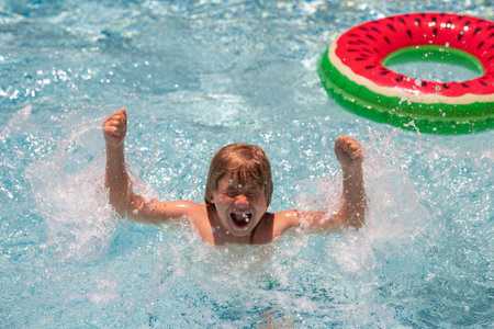 Summer vacation on tropical sea water. Child boy swim in summer swimming pool.