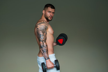 Muscular athletic fit man hard workout fitness in gym. Sport fitness and bodybuilding. Strong muscular doing exercise in the gym. Sexy muscular male body. Fitness man in the gym. Fitness training.の写真素材