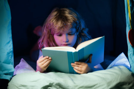 Child boy reading book. Close up portrait of kids reading story. Dreaming child read bedtime stories, fairystory or fairytale.の写真素材