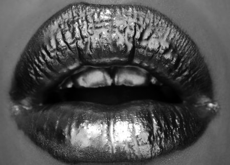 Golden lipstick closeup. Lips with metal makeup.の写真素材