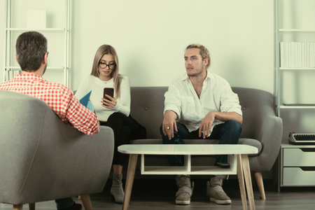 Psychologist with young couple, psychotherapist or marriage counselor listen mental health of couple. Psychological couple problem, family therapy. Depression counseling, family therapy.の写真素材