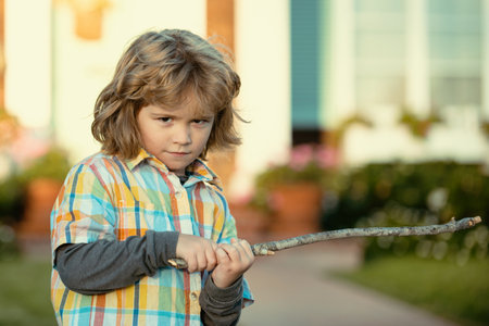 Child negative aggression. Kids emotion concept. Angry boy with stick. Kid adaptation. Bully. Bullying concept. nervous breakdown.の写真素材