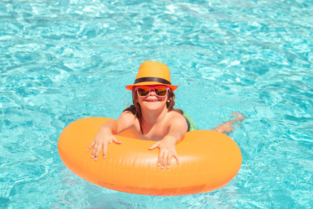 Summer vacation on tropical sea water. Kid swim in swimming pool. Water sport activity on summer...