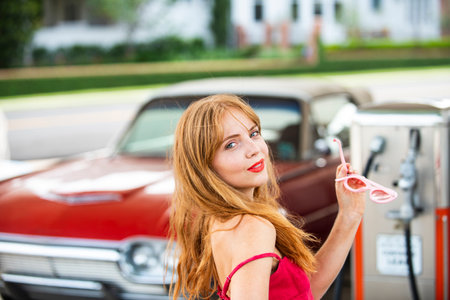 Blonde sensual young woman near car outdoor. Seductive woman face. Sensual young woman posing with sexy body. Beautiful sexy model. Beauty face. Sensual girl, sexy model portrait.の写真素材