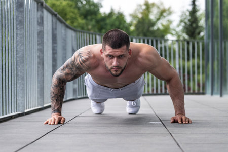 Fit guy doing exercise at gym. Handsome sporty man workout with with dumbbells on gym. Male athlete with dumbbell on fitness workout. Fitness man in gym. Muscular sportsman workout with weight in gym.の写真素材