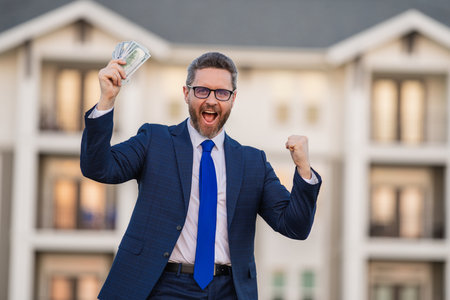 Broker or real estate agent. Business man with money banknotes. Male entrepreneur with dollar bills. Lucky boss, insurance agent, manager. Freelancer with cash.の写真素材