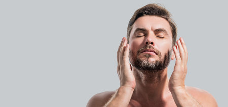 Close up portrait of man 40s having bristle isolated over gray background. Handsome man enjoy fresh perfect smooth skin. Beautiful man with perfect faces skin. Banner for header, copy space.の写真素材