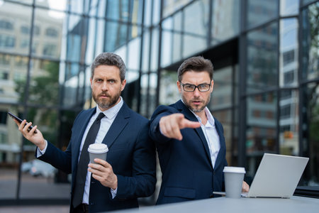 Risk management of the two business teams. Business men aggressive outdoor. Conflict and business concept. Colleagues aggressive disputing having disagreement, point you.の写真素材