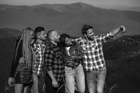 Group of friends taking a selfie in nature mountains. Students on summer vacation.の写真素材
