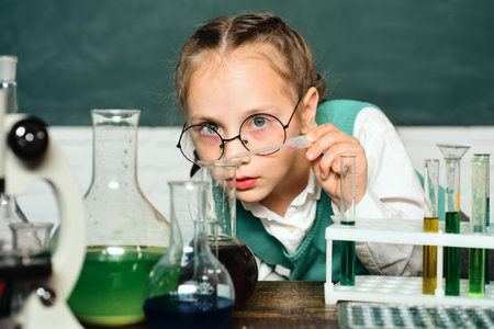 A chemistry demonstration. Back to school. Child from elementary school. Portrair close up. They carried out a new experiment in chemistry.の写真素材