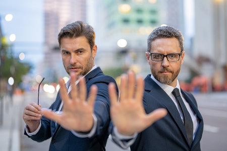 Two business mens strategy with stop gesture. Investment and financial strategy. Banking for the two business mens, risk financial operations.の写真素材