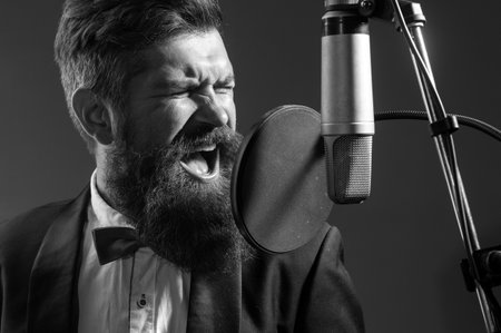 Karaoke singer. Man singing with music microphone. Classical music.の写真素材