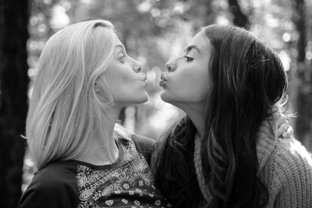Friendly kiss. Glad to see you. Girls friends kissing. Girlish friendship concept. Blonde and...