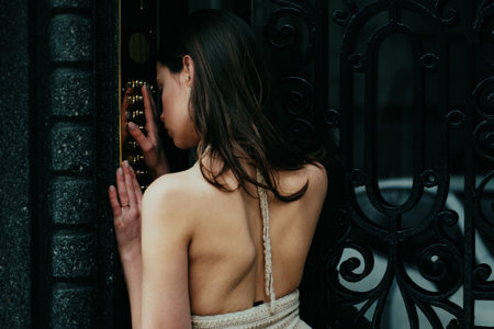 Safety female intercom button doorbell at building entrance. Young dress woman entering code on door keyboard.の写真素材
