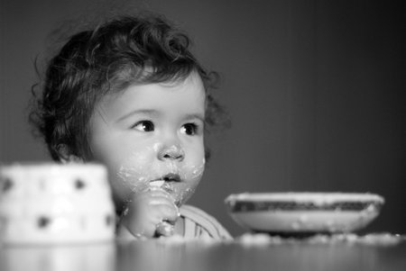 Child eating, nutrition concept. A baby eating food from a bowl.の写真素材