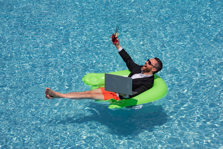 Businessman working on-line outdoor. Travel destinations, summer vacations. Funny business man in...