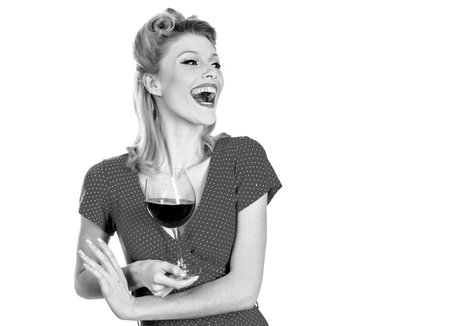 Young gorgeous brunette with glass of red wine. Beautiful happy woman drinking wine. Beauty red lips make-up girl with wineglass. Isolated on white background.の写真素材