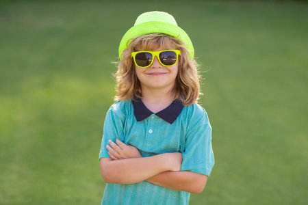 Portrait of kid in spring park outdoors. Close-up face child playing outdoors in summer park.の写真素材