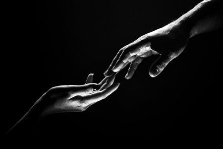 Two hands at the moment of farewell. Romantic touch with fingers, love. Help friend through a tough time. Rescue gesture, support, friendship and salvation concept. Man and woman holding hands.の素材 [FY310202763844]