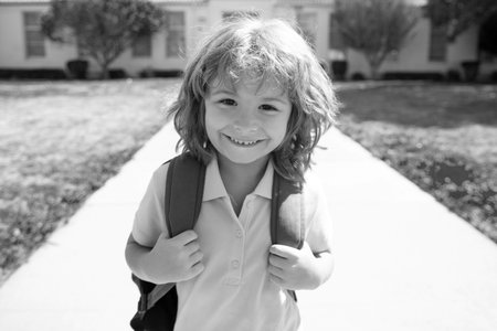 Funny happy school boy face. Elementary school kid running at school.の写真素材