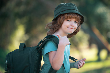 Kid with backpack hiking in scenic mountains. Boy local tourist goes on a local hike.の写真素材